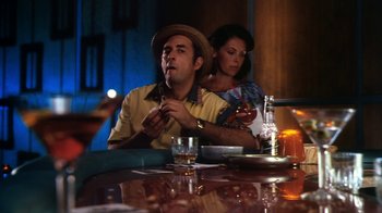 Movie still from “Forces of Nature” (1999), directed by Bronwen Hughes – A man sitting at a table with a woman; Medium shot, Low angle