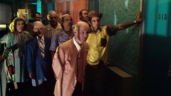 Movie still from “Forces of Nature” (1999), directed by Bronwen Hughes – A group of men standing next to each other in front of a brick wall; Medium shot, Low angle