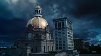 Movie still from “Forces of Nature” (1999), directed by Bronwen Hughes – A large building with a clock on the top of it; Extreme Wide shot, Low angle
