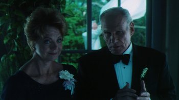 Movie still from “Forces of Nature” (1999), directed by Bronwen Hughes – An older man and woman in formal attire; Close Up shot, Low angle