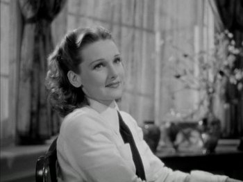 Movie still from “Four Daughters” (1938), directed by Michael Curtiz – A black and white photo of a woman sitting in a chair; Close Up shot, Low angle