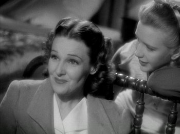 Movie still from “Four Daughters” (1938), directed by Michael Curtiz – An old black and white photo of a woman and a girl; Close Up shot, Over the shoulder angle