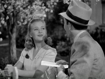 Movie still from “Four Daughters” (1938), directed by Michael Curtiz – A man and a woman talking to each other outside; Medium shot, Over the shoulder angle