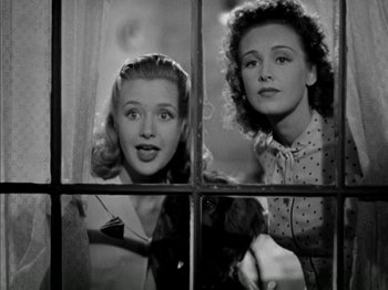 Movie still from “Four Daughters” (1938), directed by Michael Curtiz – Two young women looking out of a window; Medium shot, Low angle