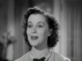 Movie still from “Four Daughters” (1938), directed by Michael Curtiz – An old photo of a woman with a bow tie; Close Up shot, High angle
