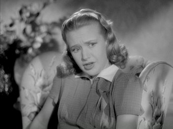 Movie still from “Four Daughters” (1938), directed by Michael Curtiz – An old black and white photo of a woman; Close Up shot, High angle