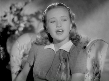 Movie still from “Four Daughters” (1938), directed by Michael Curtiz – A young woman sitting in a chair with her eyes closed; Close Up shot, Low angle