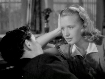 Movie still from “Four Daughters” (1938), directed by Michael Curtiz – A man and a woman sitting on a couch; Close Up shot, High angle