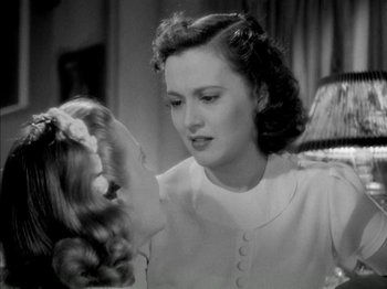 Movie still from “Four Daughters” (1938), directed by Michael Curtiz – An old photo of a woman and a little girl; Close Up shot, Over the shoulder angle
