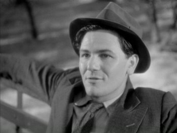 Movie still from “Four Daughters” (1938), directed by Michael Curtiz – A man wearing a hat and a jacket; Close Up shot, Low angle