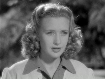 Movie still from “Four Daughters” (1938), directed by Michael Curtiz – A black and white photo of a young woman; Close Up shot, High angle