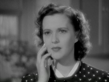 Movie still from “Four Daughters” (1938), directed by Michael Curtiz – A black - and - white photo of a woman talking on a phone; Close Up shot, High angle