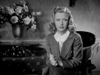 Movie still from “Four Daughters” (1938), directed by Michael Curtiz – A woman sitting on a chair in a room; Close Up shot, High angle