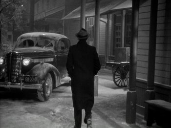 Movie still from “Four Daughters” (1938), directed by Michael Curtiz – A man walking down the street in the snow; Wide shot, High angle
