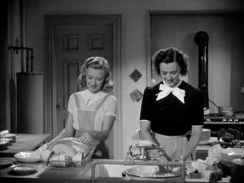 Movie still from “Four Daughters” (1938), directed by Michael Curtiz – Two women in a kitchen preparing a meal together; Medium shot, Low angle