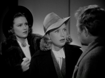 Movie still from “Four Daughters” (1938), directed by Michael Curtiz – Two women and a man are talking to each other; Close Up shot, High angle