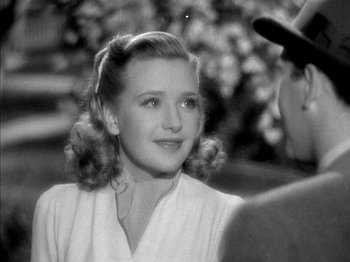 Movie still from “Four Daughters” (1938), directed by Michael Curtiz – An old black and white photo of a young woman; Close Up shot, Over the shoulder angle