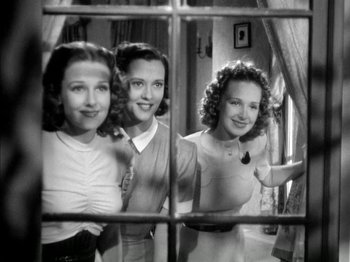 Movie still from “Four Daughters” (1938), directed by Michael Curtiz – A group of women standing next to each other in front of a window; Medium shot, Low angle