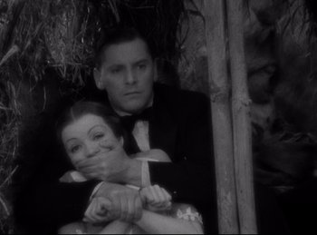 Movie still from “Four Frightened People” (1934), directed by Cecil B. DeMille – A man and a woman are posing for a picture; Close Up shot, High angle