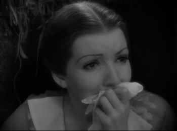 Movie still from “Four Frightened People” (1934), directed by Cecil B. DeMille – A black - and - white photo of a woman holding a napkin to her mouth; Close Up shot, High angle