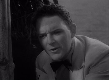 Movie still from “Four Frightened People” (1934), directed by Cecil B. DeMille – A black - and - white photo of a man in a suit; Close Up shot, High angle