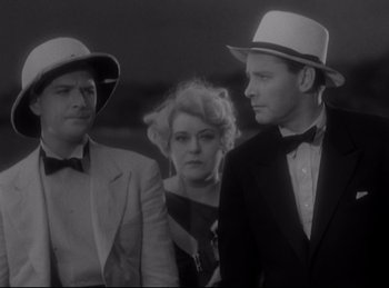 Movie still from “Four Frightened People” (1934), directed by Cecil B. DeMille – A group of people standing next to each other wearing hats; Medium shot, High angle
