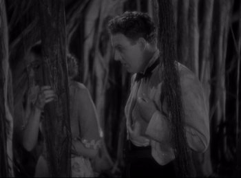 Movie still from “Four Frightened People” (1934), directed by Cecil B. DeMille – A black and white photo of a man and a woman; Medium shot, Low angle