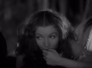 Movie still from “Four Frightened People” (1934), directed by Cecil B. DeMille – A black - and - white photo of a woman holding her hand to her mouth; Close Up shot, High angle