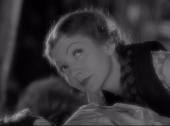 Movie still from “Four Frightened People” (1934), directed by Cecil B. DeMille – A black - and - white photo of a woman looking over her shoulder; Close Up shot, Low angle