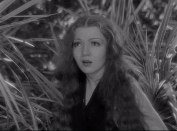 Movie still from “Four Frightened People” (1934), directed by Cecil B. DeMille – A black and white photo of a woman with long red hair; Close Up shot, High angle