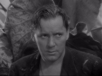 Movie still from “Four Frightened People” (1934), directed by Cecil B. DeMille – Black and white photograph of a man in a jacket; Close Up shot, Low angle