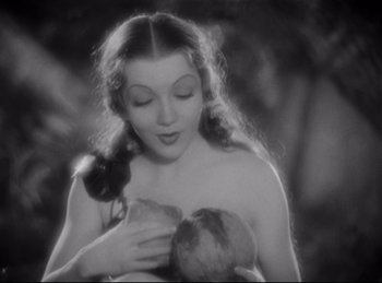 Movie still from “Four Frightened People” (1934), directed by Cecil B. DeMille – A black and white photo of a woman holding a fruit; Close Up shot, High angle