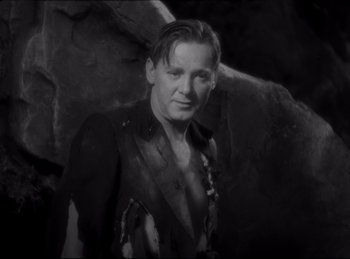 Movie still from “Four Frightened People” (1934), directed by Cecil B. DeMille – A black and white photo of a man in a jacket; Medium shot, Low angle