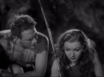 Movie still from “Four Frightened People” (1934), directed by Cecil B. DeMille – A black and white photo of a man and a woman holding fishing rods; Medium shot, High angle