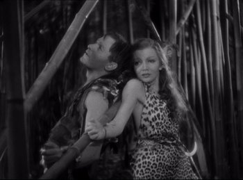 Movie still from “Four Frightened People” (1934), directed by Cecil B. DeMille – A man and a woman are hugging in a jungle; Medium shot, High angle