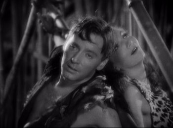 Movie still from “Four Frightened People” (1934), directed by Cecil B. DeMille – A man and a woman in native american garb; Close Up shot, High angle