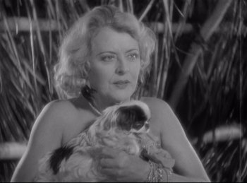 Movie still from “Four Frightened People” (1934), directed by Cecil B. DeMille – An older woman holding a cat in her arms; Close Up shot, High angle