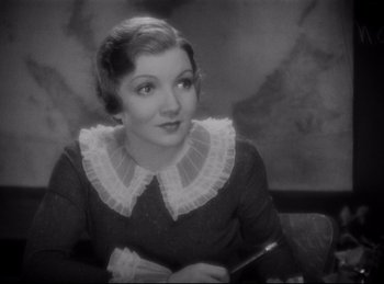 Movie still from “Four Frightened People” (1934), directed by Cecil B. DeMille – An old photo of a woman in a black dress; Close Up shot, High angle