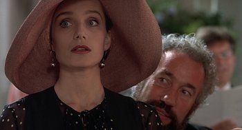 Movie still from “Four Weddings and a Funeral” (1994), directed by Mike Newell – A woman wearing a hat and a man with a beard; Close Up shot, Over the shoulder angle