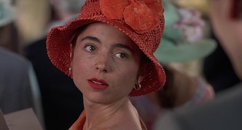 Movie still from “Four Weddings and a Funeral” (1994), directed by Mike Newell – A person wearing a hat; Close Up shot, Over the shoulder angle