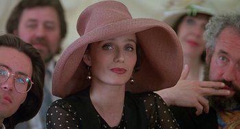 Movie still from “Four Weddings and a Funeral” (1994), directed by Mike Newell – A woman wearing a pink hat and a polka dot blouse; Close Up shot, Low angle