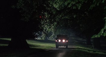 Movie still from “Four Weddings and a Funeral” (1994), directed by Mike Newell – A car driving down a road at night; Wide shot, Low angle