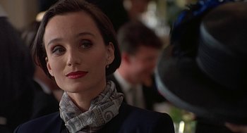 Movie still from “Four Weddings and a Funeral” (1994), directed by Mike Newell – A person wearing a suit and a scarf; Close Up shot, Over the shoulder angle