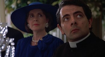 Movie still from “Four Weddings and a Funeral” (1994), directed by Mike Newell – A man and a woman wearing hats and a dress; Close Up shot, Low angle