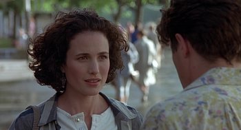 Movie still from “Four Weddings and a Funeral” (1994), directed by Mike Newell – A person talking to another person; Close Up shot, Over the shoulder angle