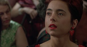 Movie still from “Four Weddings and a Funeral” (1994), directed by Mike Newell – A person with red lipstick on her lips; Close Up shot, Over the shoulder angle