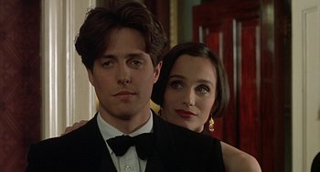 Movie still from “Four Weddings and a Funeral” (1994), directed by Mike Newell – A man and a woman posing for a picture; Close Up shot, Low angle