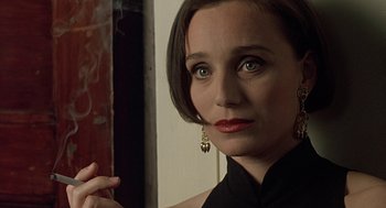 Movie still from “Four Weddings and a Funeral” (1994), directed by Mike Newell – A person wearing a black shirt; Close Up shot, Over the shoulder angle