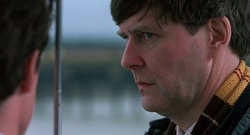 Movie still from “Four Weddings and a Funeral” (1994), directed by Mike Newell – A person with blue eyes; Close Up shot, Low angle