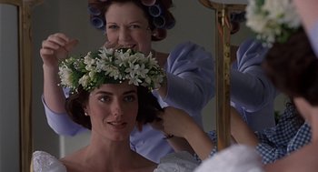 Movie still from “Four Weddings and a Funeral” (1994), directed by Mike Newell – A woman is getting her hair done while another woman looks on; Close Up shot, Over the shoulder angle
